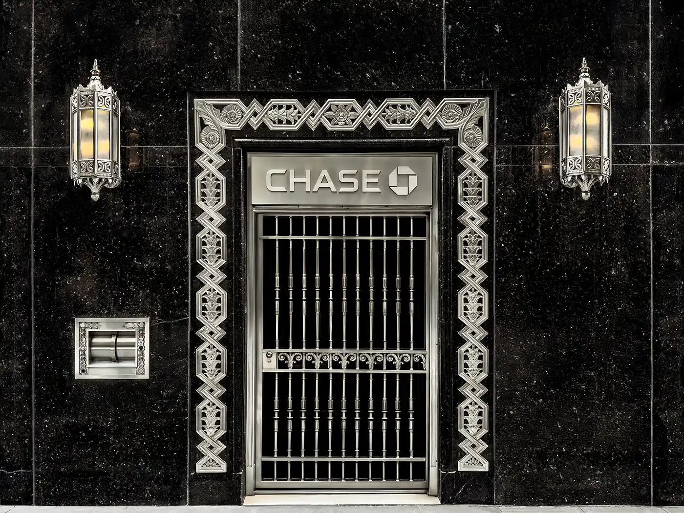 A remarkable Art Deco detail from the Chrysler Building in New York City, showing the Chase Bank entrance on Lexington Avenue. This photograph highlights the sleek geometry and decorative glass and steel screens designed to harmonize with William Van Alen&rsquo;s iconic skyscraper.
