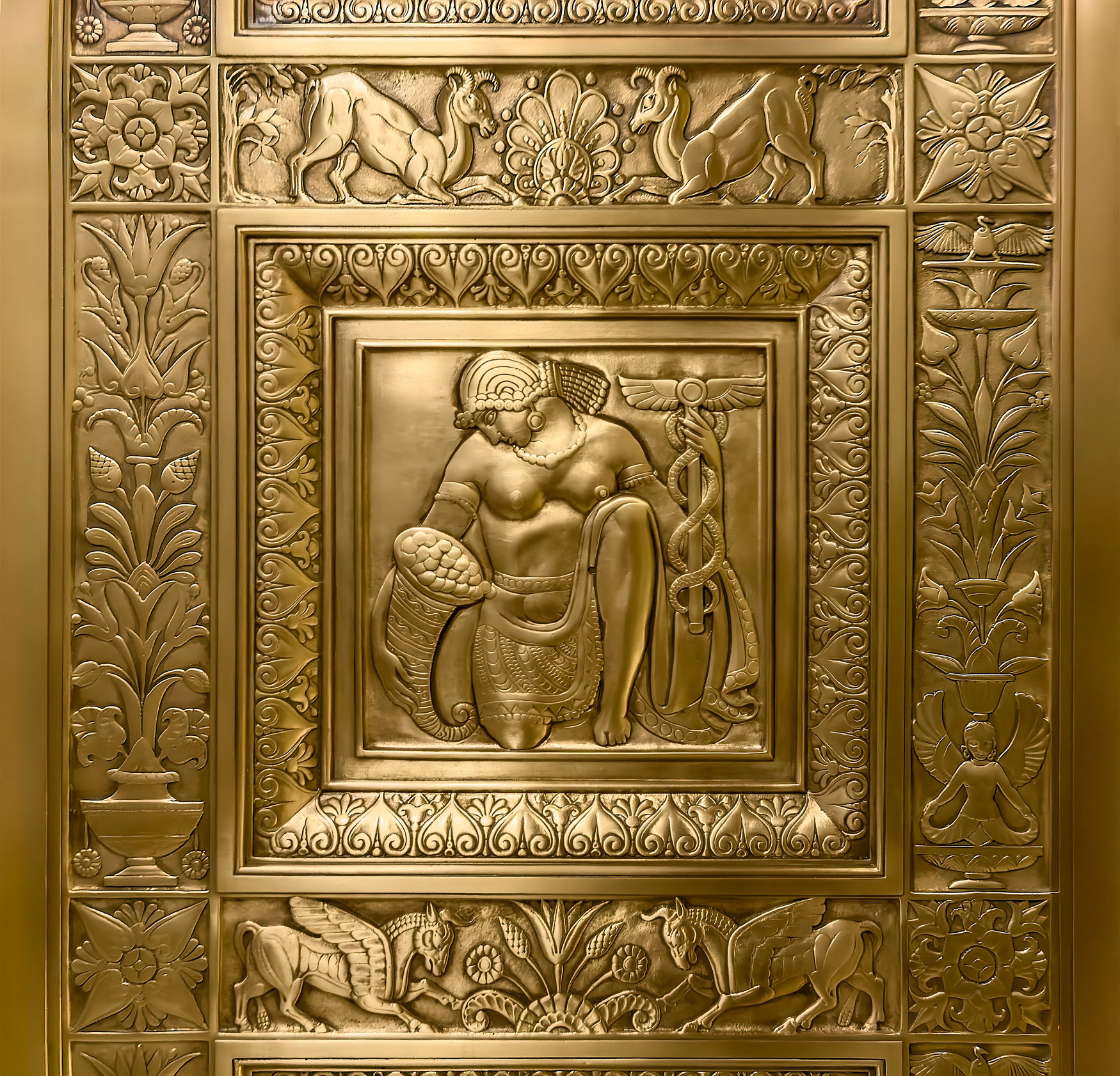 The Wealth Bearer (Panel 144) - FINANCE Agitation. Gilded Bronze Radiator Grill in the vestibule of the Chanin Building. By Rene Paul Chambellan 1929.