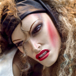 Shop-window mannequin with dramatic makeup and confrontational pose in Copenhagen boutique window, Denmark, 1986.